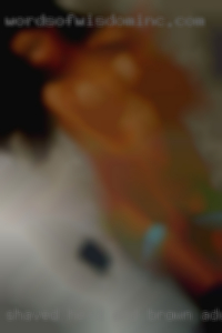 Shaved head and brown adult eyes.